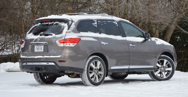 Snow-covered 2013 Nissan Pathfinder long-term vehicle - rear three-quarter view