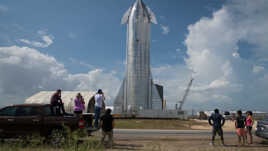 BOCA CHICA, TX - SEPTEMBER 28: Space enthusiasts look at a prototype of SpaceX's Starship spacecraft at the company's Texas launch facility on September 28, 2019 in Boca Chica near Brownsville, Texas. The Starship spacecraft is a massive vehicle meant to take people to the Moon, Mars, and beyond. (Photo by Loren Elliott/Getty Images)