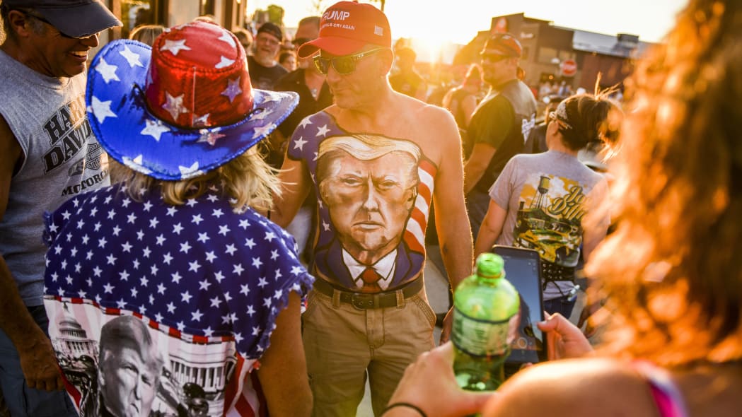 STURGIS, SD - AUGUST 07: Johne Riley walks down Main Street showing off his chest painted with a portrait of President Donald Trump during the 80th Annual Sturgis Motorcycle Rally on August 7, 2020 in Sturgis, South Dakota. While the rally usually attracts around 500,000 people, officials estimate that more than 250,000 people may still show up to this year's festival despite the coronavirus pandemic. (Photo by Michael Ciaglo/Getty Images)