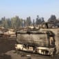 A charred pickup truck sits among the ruins of the Coleman Creek Estates mobile home park in Phoenix, Ore., Thursday, Sept. 10, 2020. The area was destroyed when a wildfire swept through on Tuesday, Sept. 8.. (AP Photo/Gillian Flaccus)