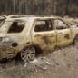 A burned out car is seen near someone's home after the passing of the Holiday Farm fire in McKenzie Bridge, Oregon on September 10, 2020. - California firefighters battled the state's largest ever inferno on September 10, as tens of thousands of people fled blazes up and down the US West Coast and officials warned the death toll could shoot up in coming days. At least eight people have been confirmed dead in the past 24 hours across California, Oregon and Washington, but officials say some areas are still impossible to reach, meaning the number is likely to rise. (Photo by Tyee Burwell / AFP) (Photo by TYEE BURWELL/AFP via Getty Images)