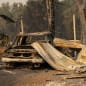 PHOENIX, OR - SEPTEMBER 10: A damaged home and car are seen in a mobile home park destroyed by fire on September 10, 2020 in Phoenix, Oregon. Hundreds of homes in the town have been lost due to wildfire. (Photo by David Ryder/Getty Images)