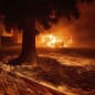 Flames consume a Kentucky Fried Chicken as the Camp Fire tears through Paradise, Calif., on Thursday, Nov. 8, 2018. Tens of thousands of people fled a fast-moving wildfire Thursday in Northern California, some clutching babies and pets as they abandoned vehicles and struck out on foot ahead of the flames that forced the evacuation of an entire town and destroyed hundreds of structures.  (AP Photo/Noah Berger)
