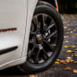 The 2023 Chrysler Pacifica Road Tripper rolls on 20-inch wheels (18-inch wheels on the Hybrid) that are Luster Gray, as are the center caps, which feature a Brilliant Orange Chrysler wing badge logo.