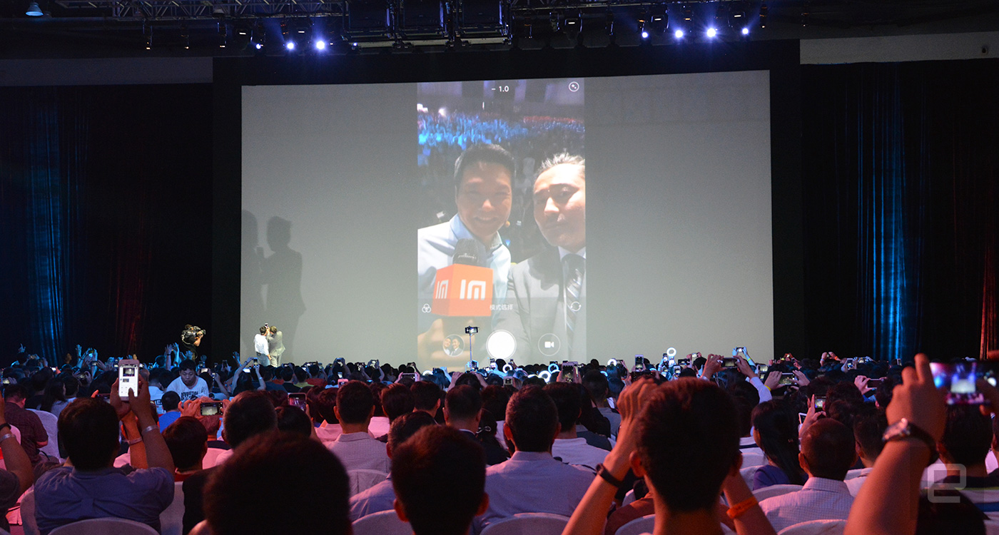 Xiaomi CEO Lei Jun with Redmi celebrity spokesperson Wu Xiubo take a selfie on the stage.