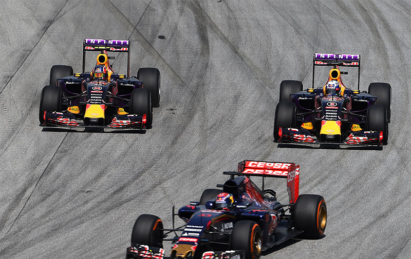A Toro Rosso ahead of two Red Bulls at the 2015 Malaysian F1 Grand Prix.