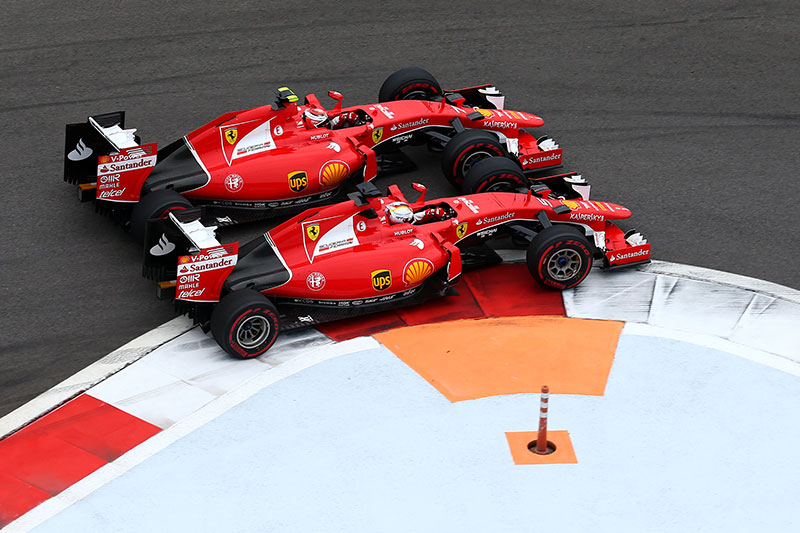 Ferrari driver Sebastian Vettel passes teammate Kimi Raikkonen on the inside of Turn 1 at the 2015 Russian Grand Prix.