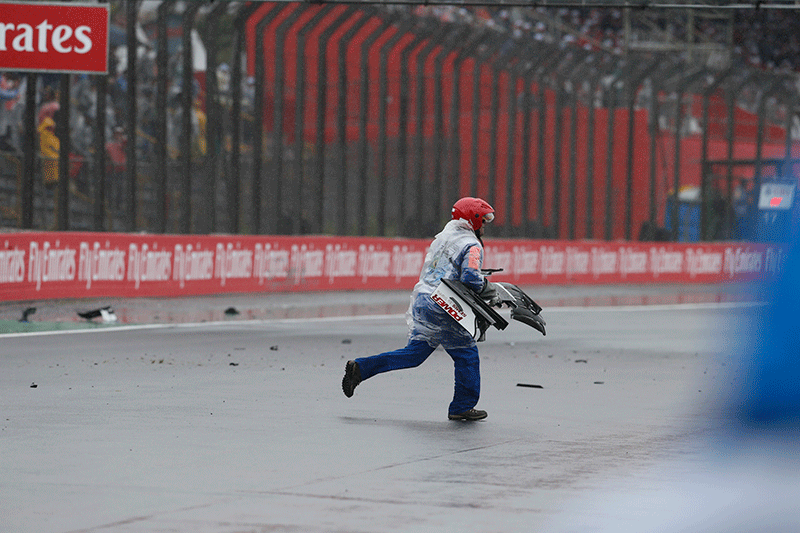 A track official collects debris from a car during the Brazilian Formula One Grand Prix at the Interlagos race track in Sao Paulo, Brazil, Sunday, Nov. 13, 2016.