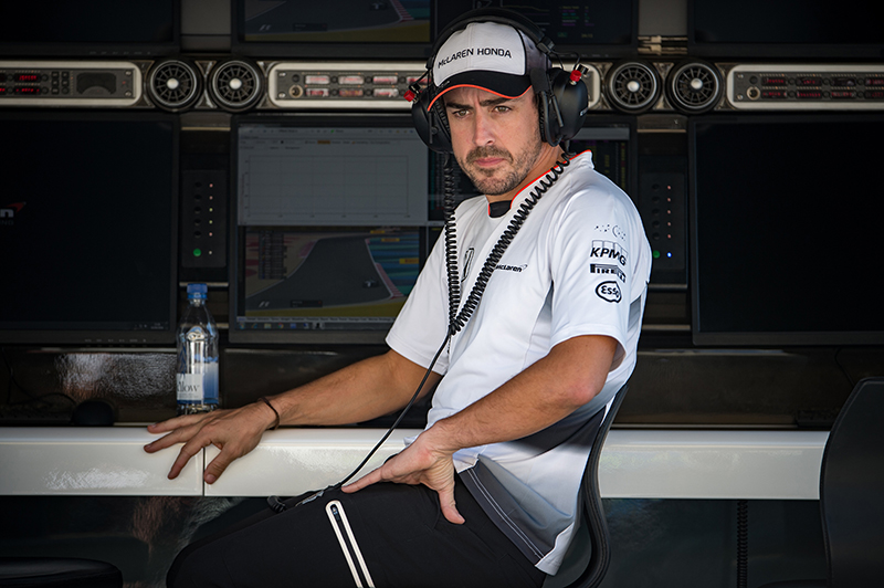 Fernando Alonso sits on the pit wall at the 2016 Bahrain F1 Grand Prix.