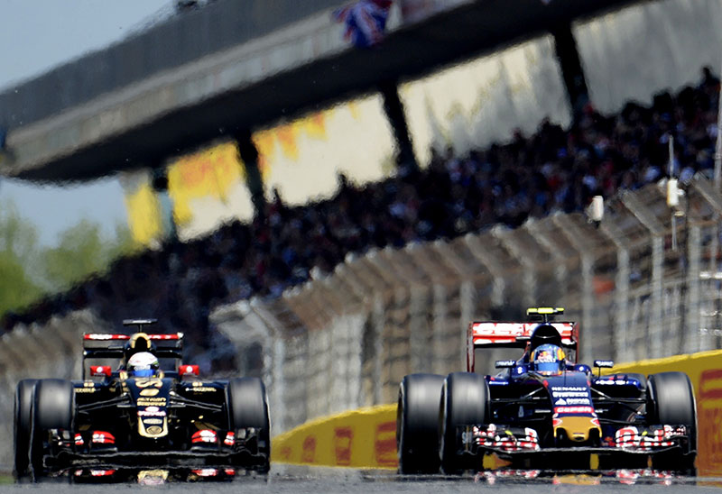 Carlos Sainz leads Romain Grosjean at the 2015 Spanish Formula One Grand Prix.