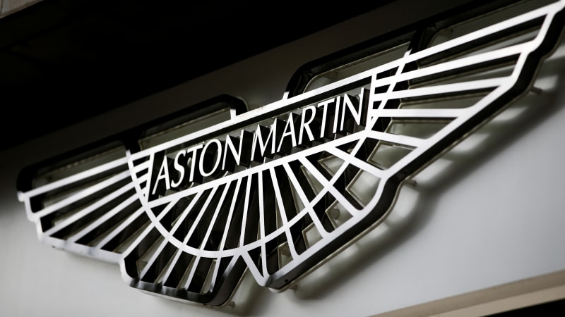 an aston martin logo is seen on the outside of a dealership in central london