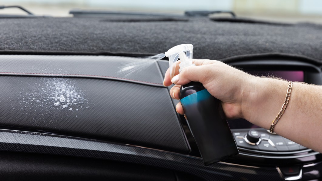 Man S Hand Spraying Cleaning Solution On Car Interior 