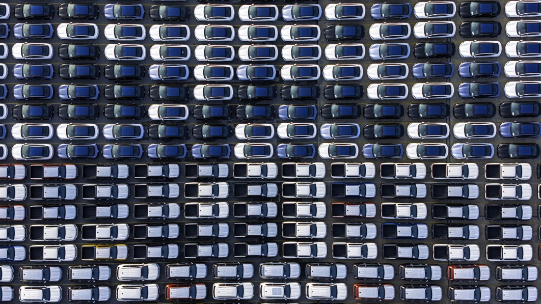 aerial_top_view_car_park_at_sea_port_or_manufacture_waiting_for_logistics_.jpeg