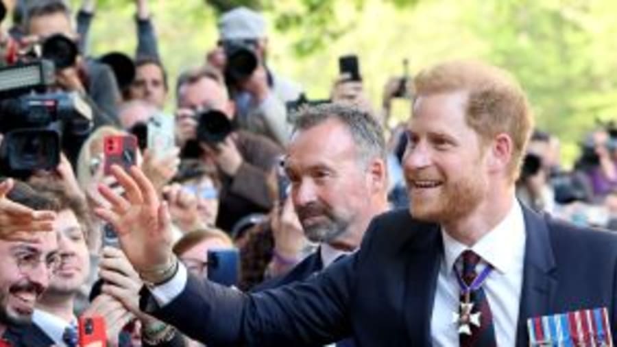 Prince Harry beams as fans line streets after King Charles reunion fail